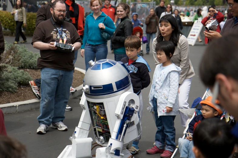 a star wars character on display with people watching