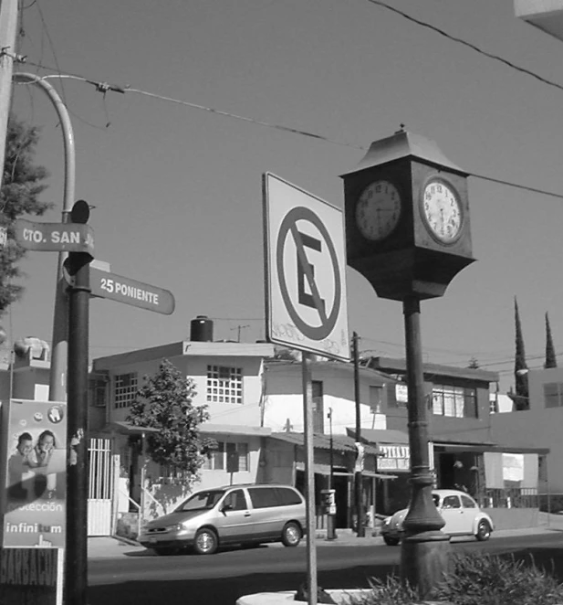 there are cars and cars in front of the clock