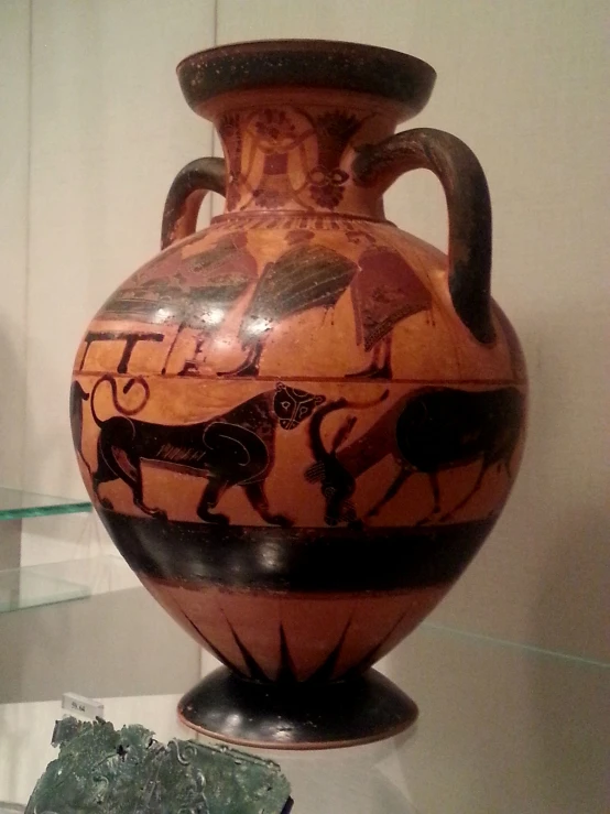 an old brown vase with drawings on the bottom