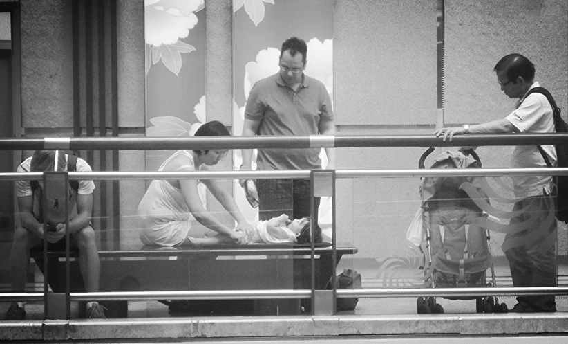 a woman getting her feet examined by a man outside