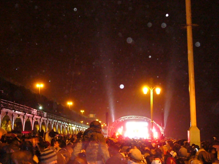 a crowd is watching some music on stage