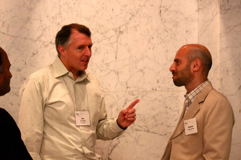 a man talking with other people in a room