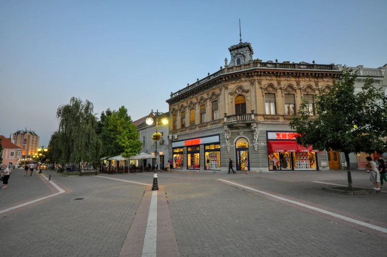 a city street with a lot of buildings on the corner