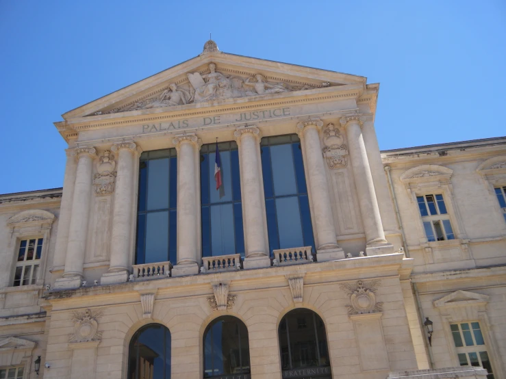 the front of a large building on the side of a street