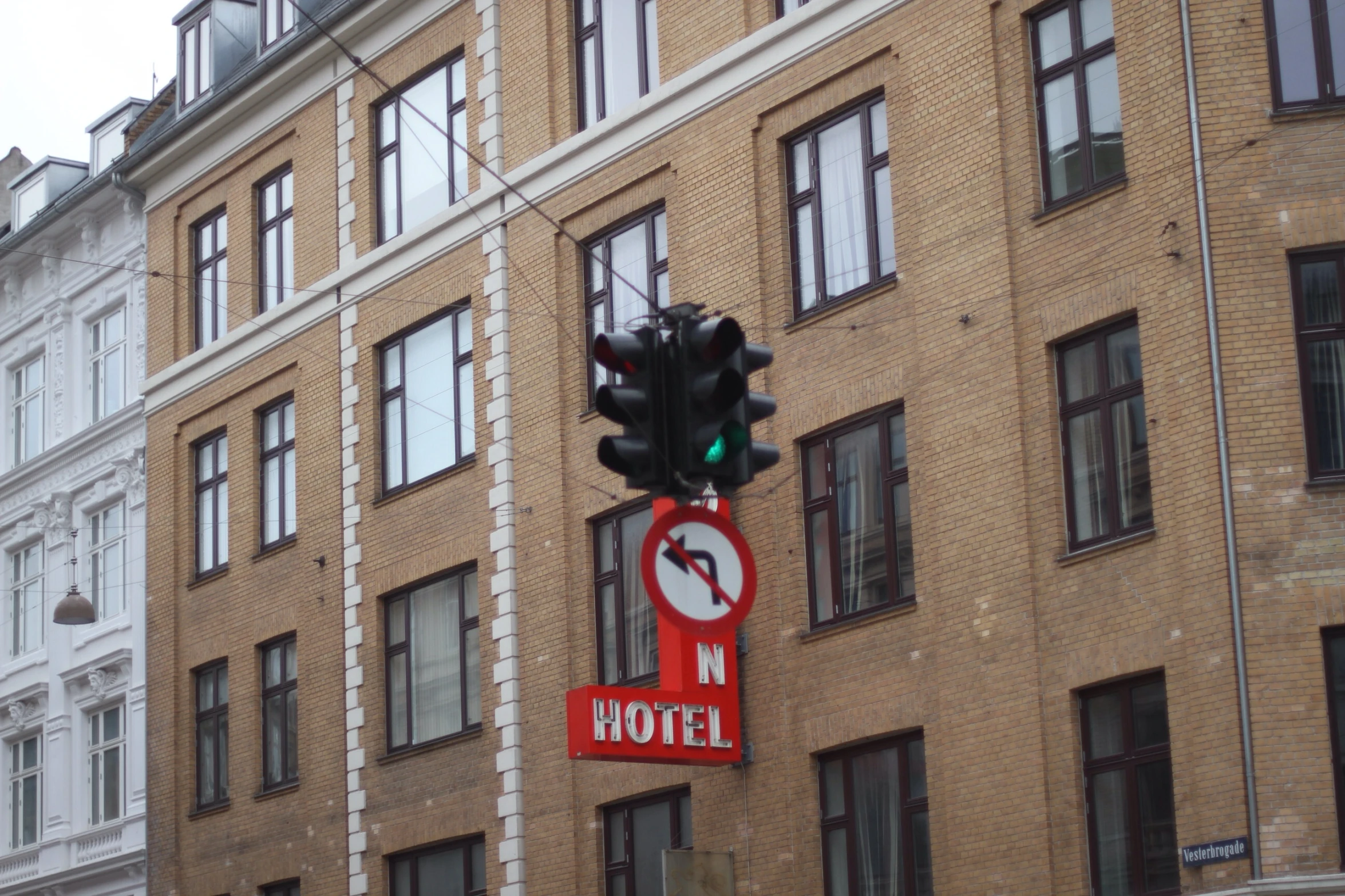 there is a street light next to a brick building