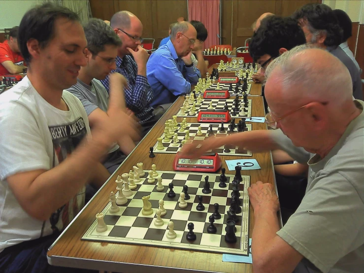 people sitting at tables playing chess at an event