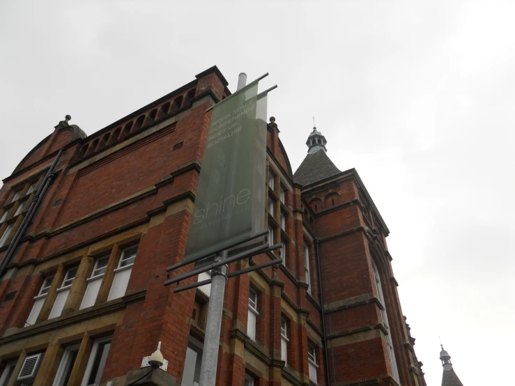 a sign is mounted to the side of a building