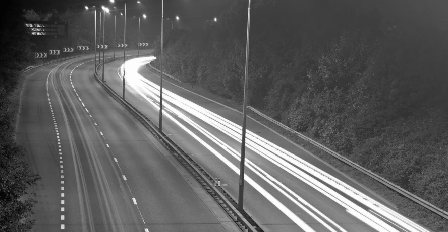 a freeway at night with streaks of light going through it