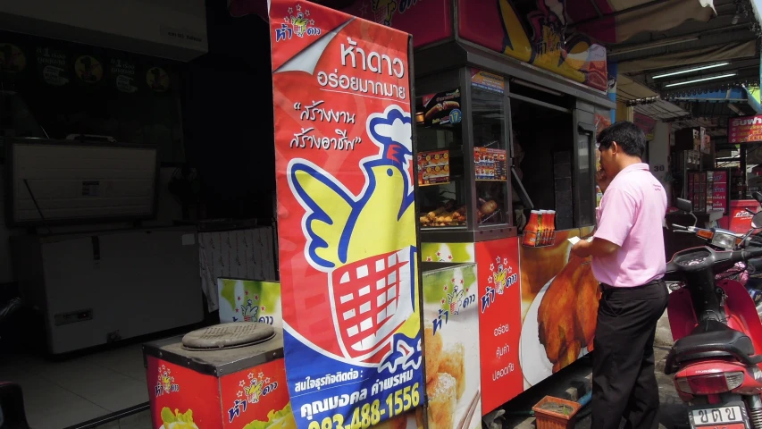 a man is standing in front of a food cart