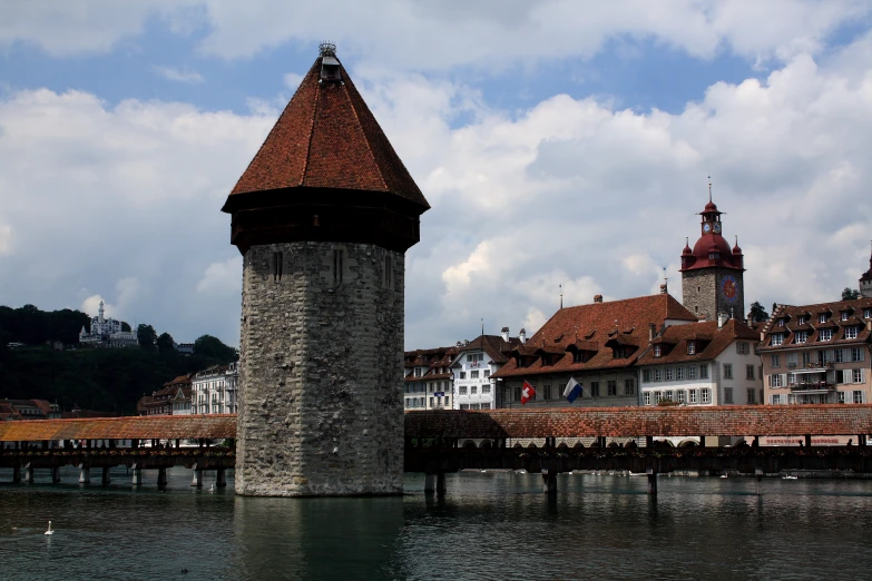 a tower that is on a bridge near the water