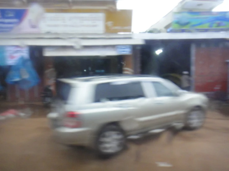 blurry po of a white vehicle coming down a road