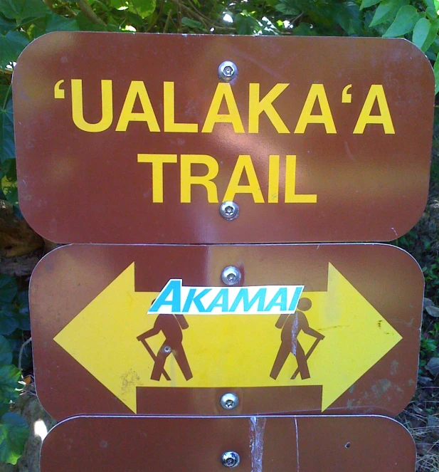 a wooden sign on a sidewalk pointing left to right