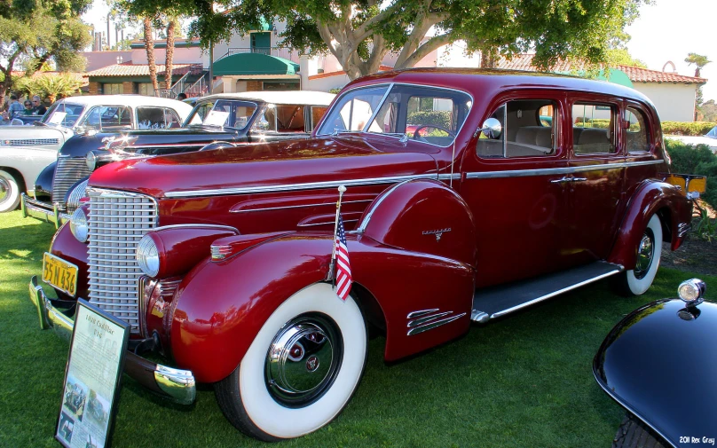 an old car sitting next to others antique cars