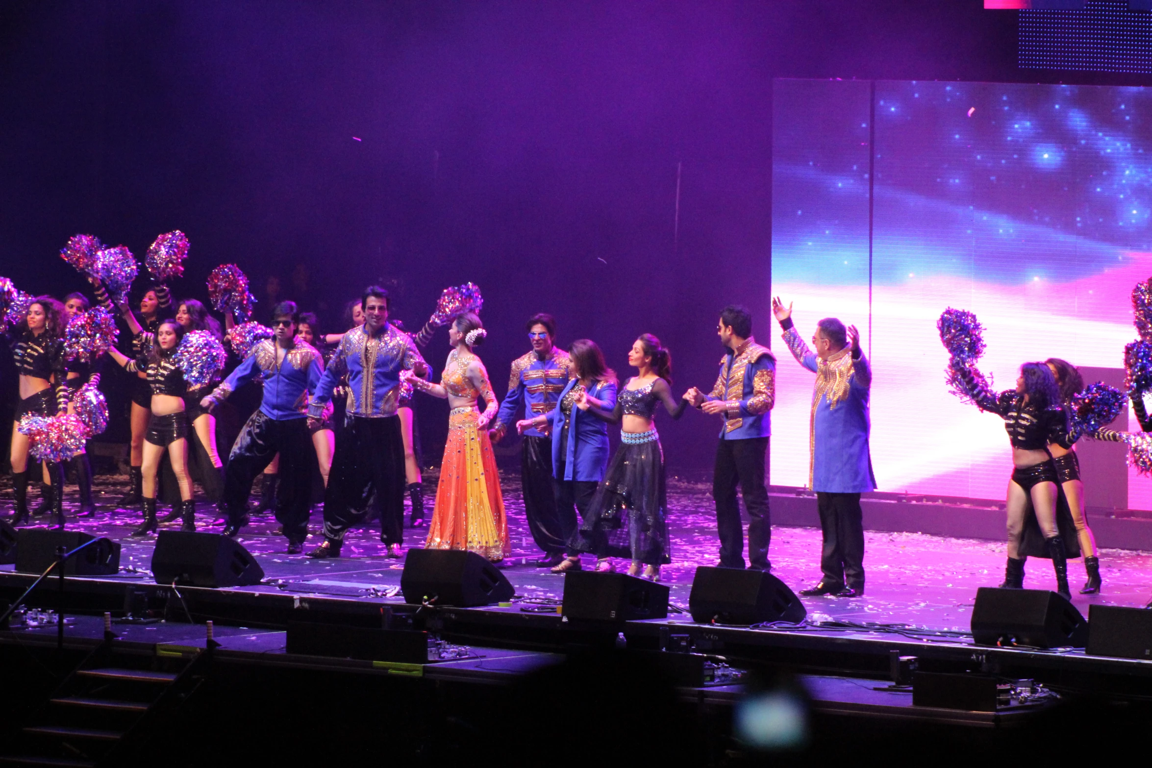 several dancers perform on a stage while people watch