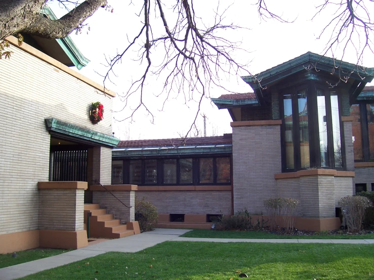 a large house with many windows and two towers in the front