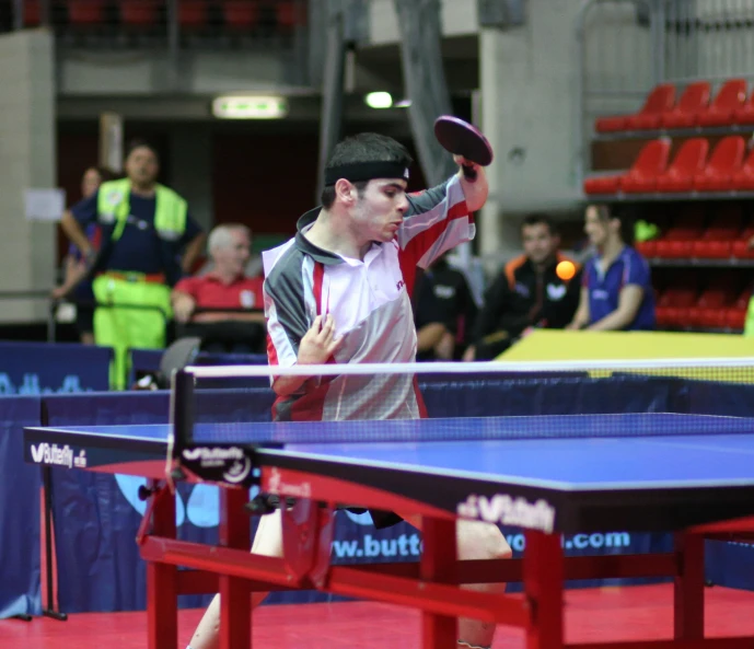 a man playing table tennis at the ping pong