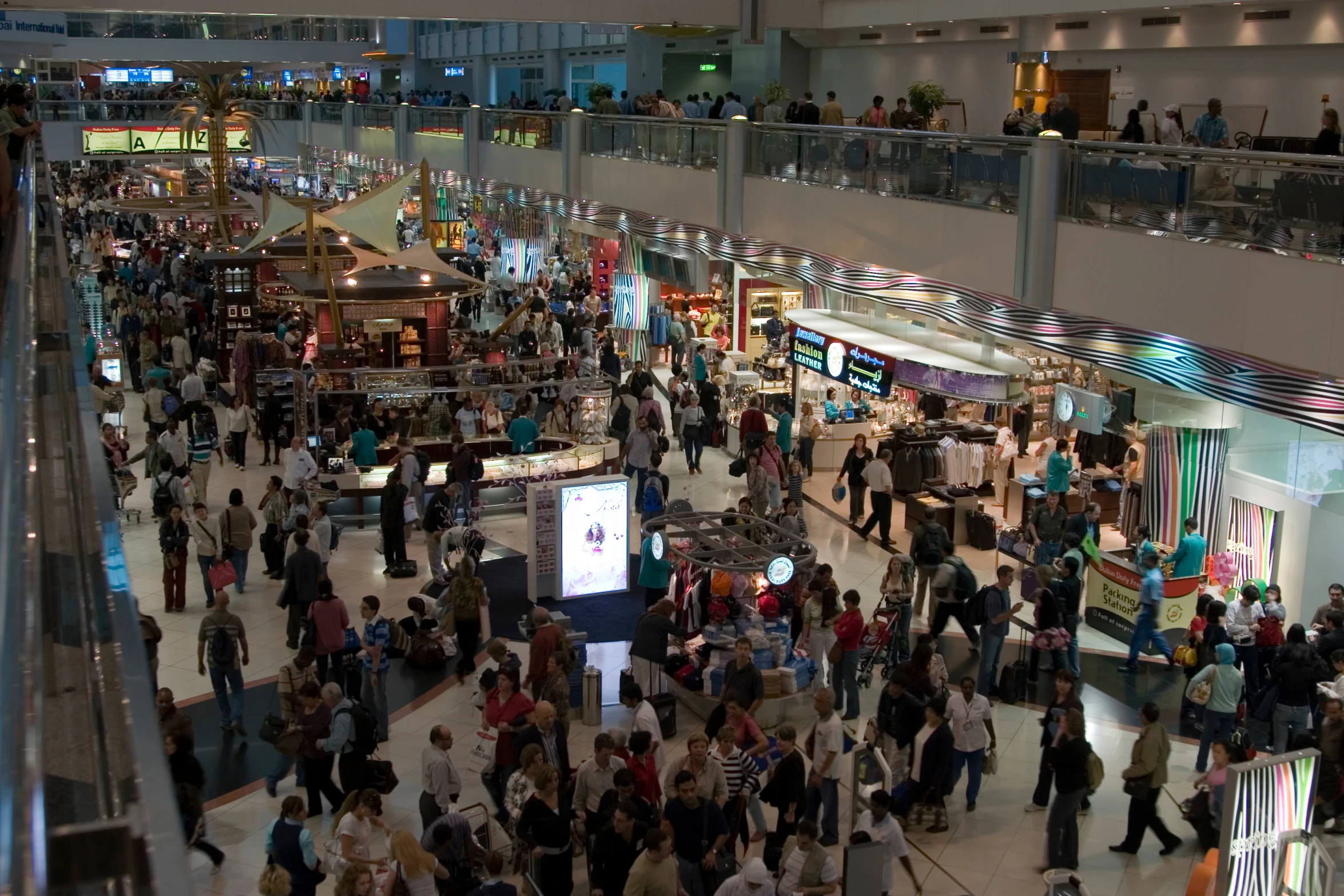 a group of people standing in the middle of a mall