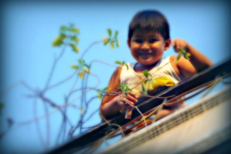 a little boy is playing on the railing