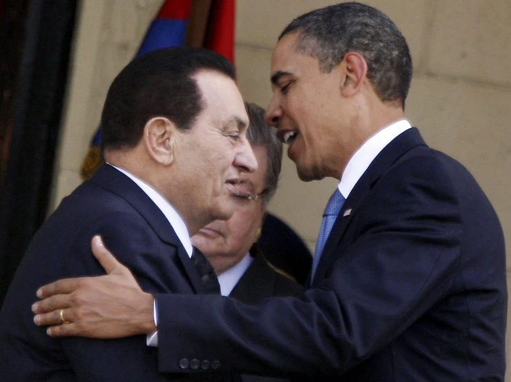 two men in suits hugging each other