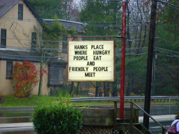 a sign on a street with the words thanks for some more hungry people and friendly people