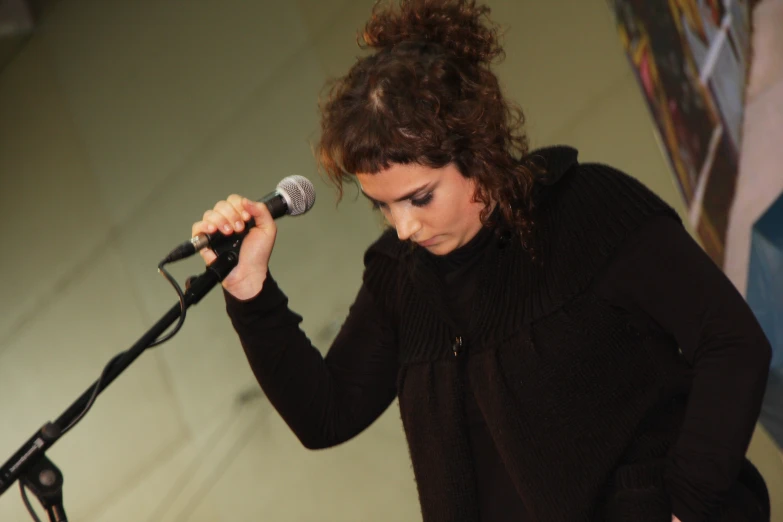 a woman with curly hair and a microphone