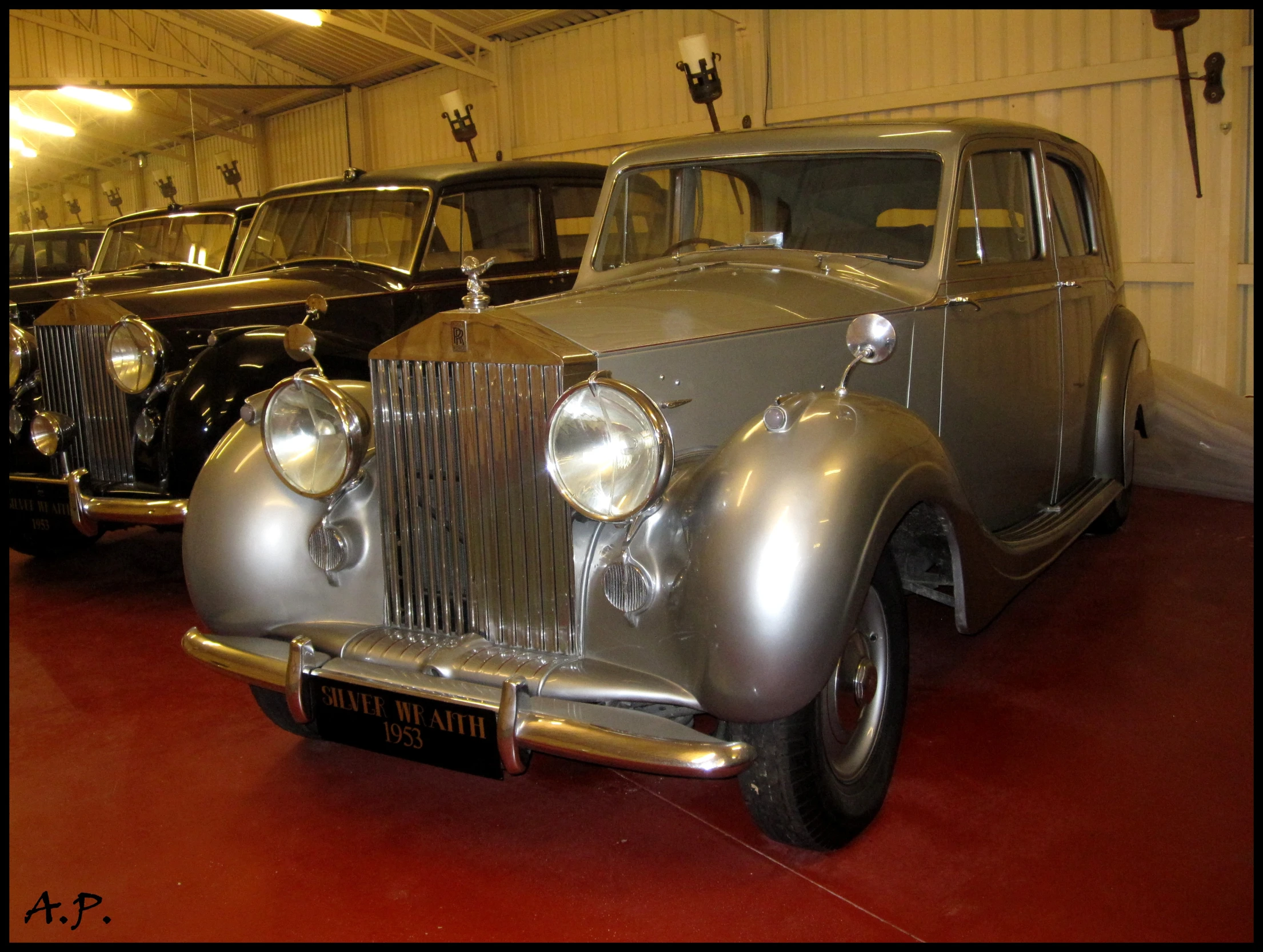 two old classic cars are parked in a row