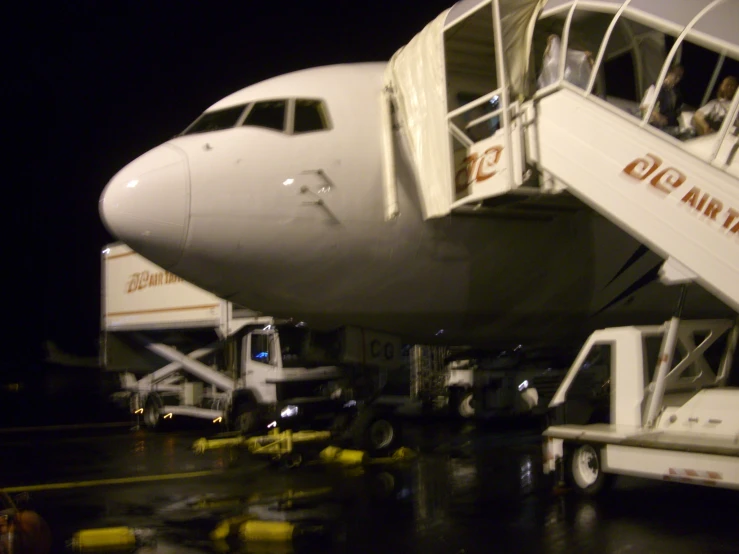 people getting off an airplane with steps going down