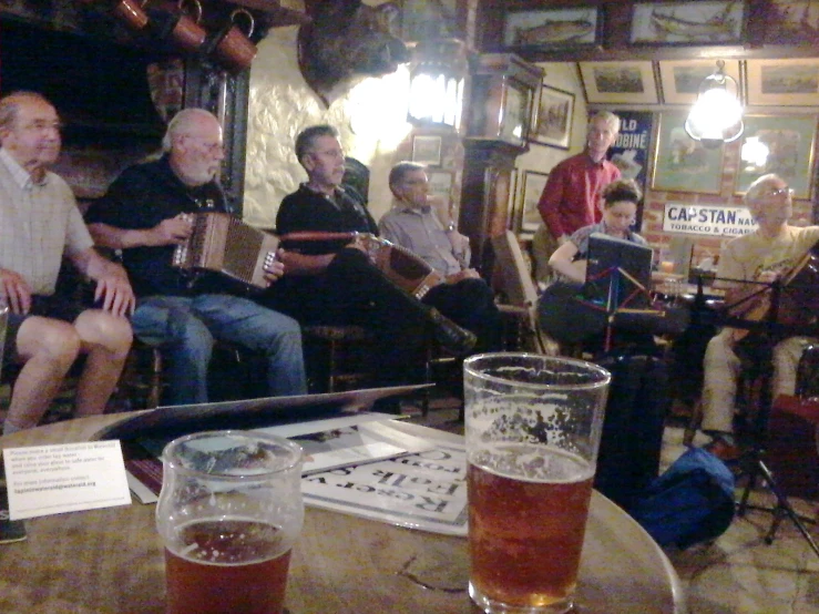 a group of people sitting around a table with musical instruments