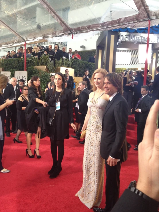 a group of people on a red carpet