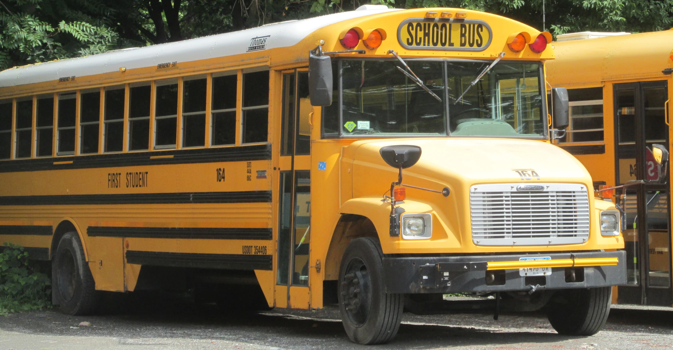 three school buses that are parked together in the street