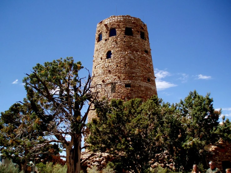 a large brown tower sitting between two trees