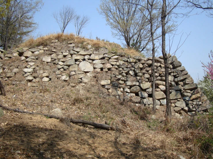 a wall made of rocks sitting on top of a hill