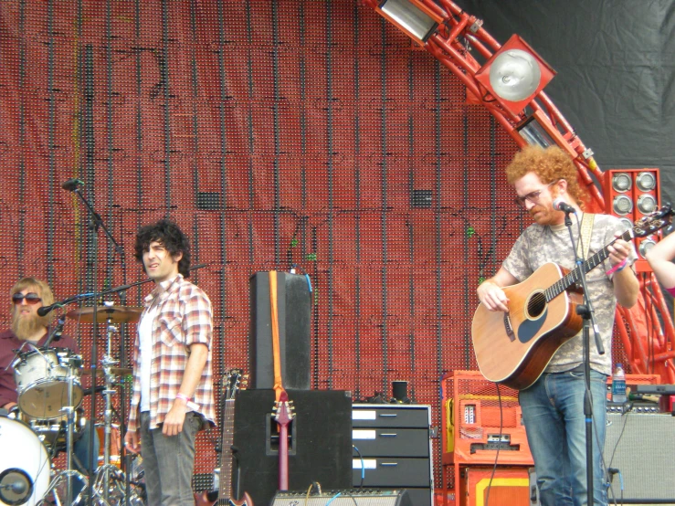 a person is singing and playing a guitar