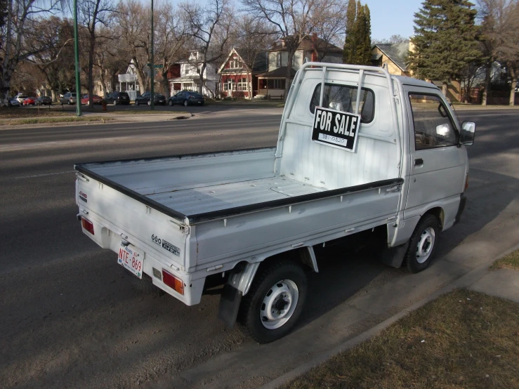 a silver truck parked on the side of the road with a sign that reads star stickers on it