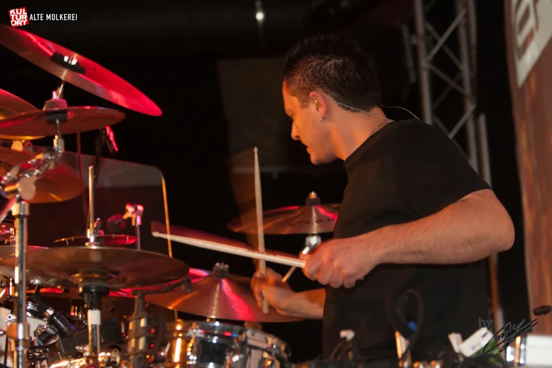 a man with headphones playing the drums