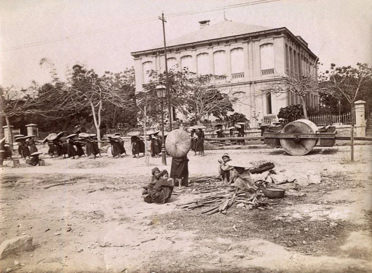 an old black and white po of people gathered on the side of a road