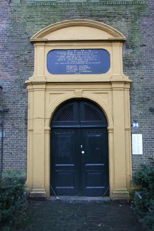 a large building with a door and brick wall