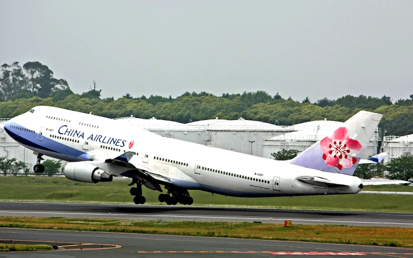 an airplane takes off on an airstrip from an airport