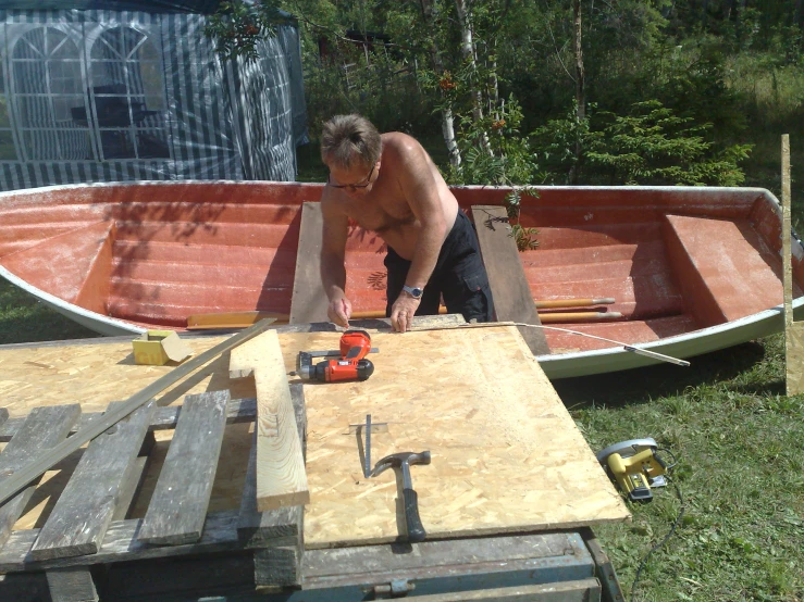 a man working on a boat that is in the water