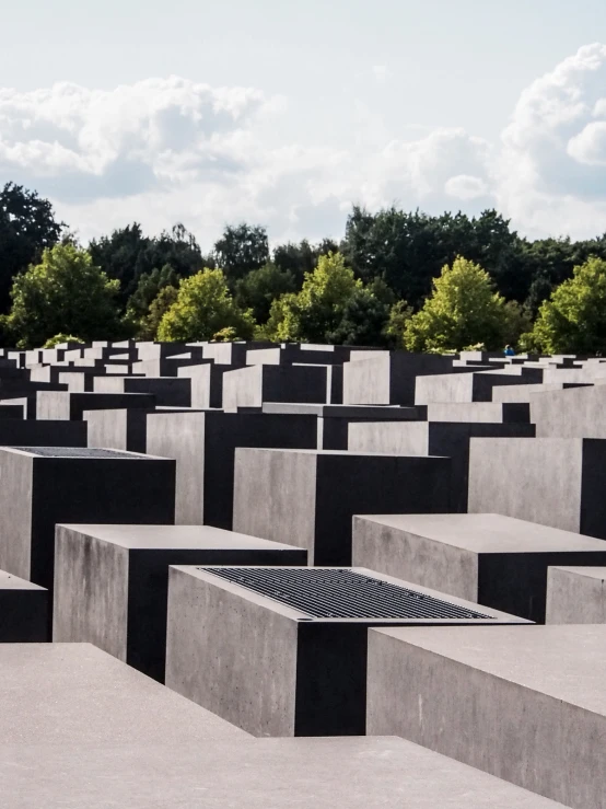 several square cement structures with a sky in the background