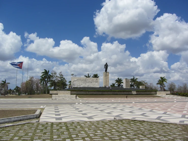 a white tiled walkway leads to the monument