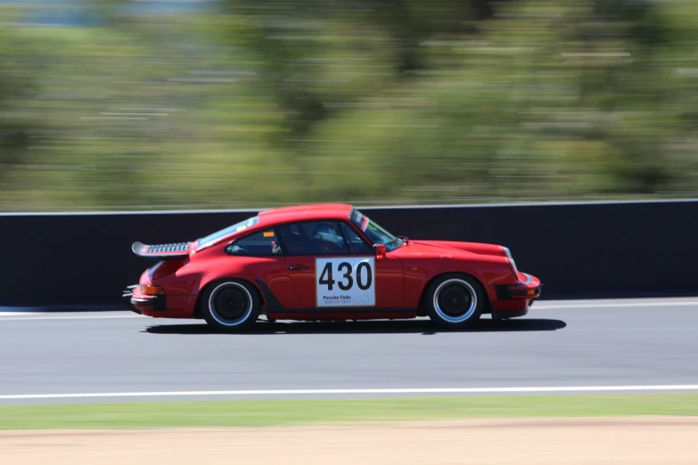 a red sports car turning around a curve