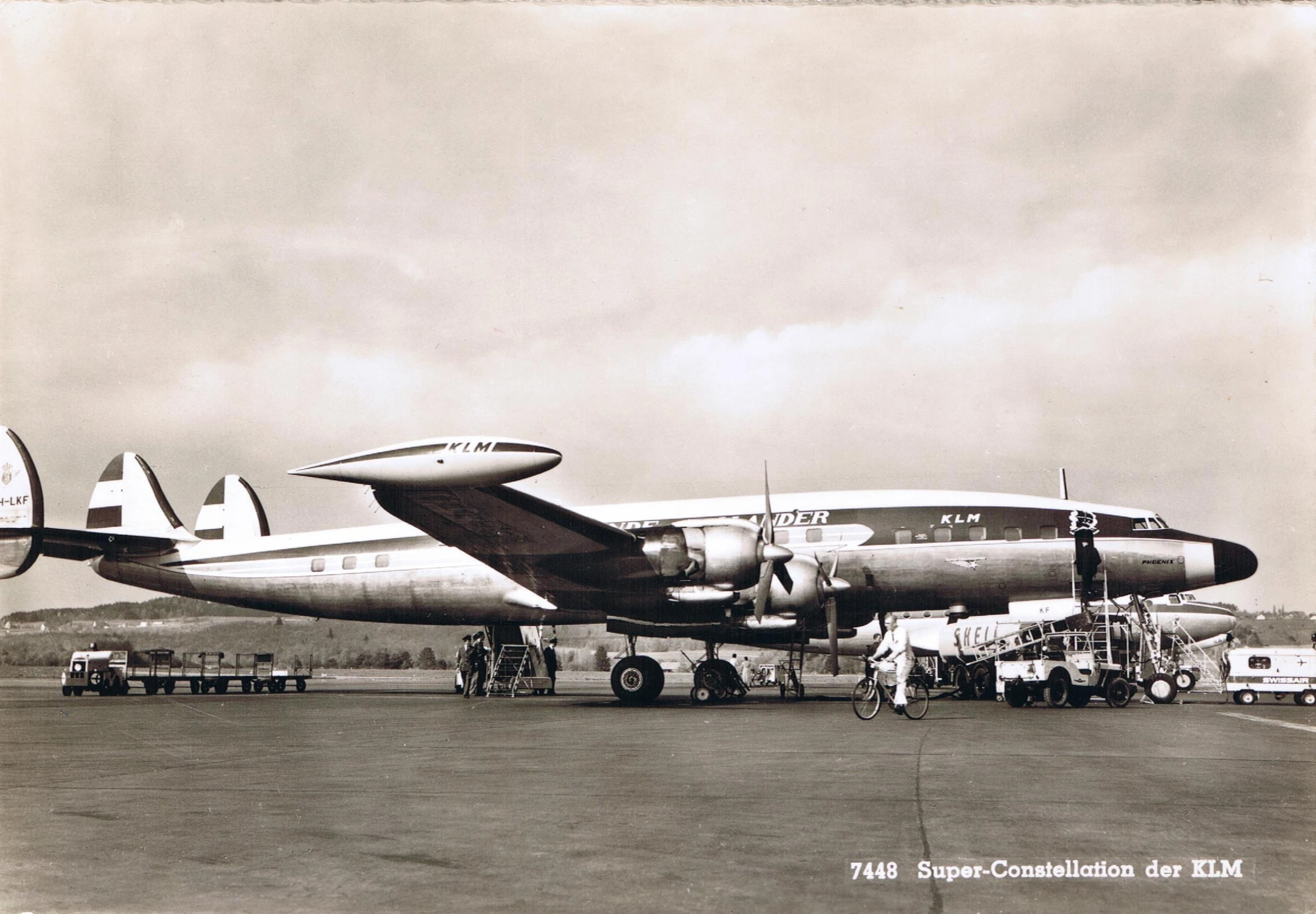 an airplane parked next to a truck on a runway