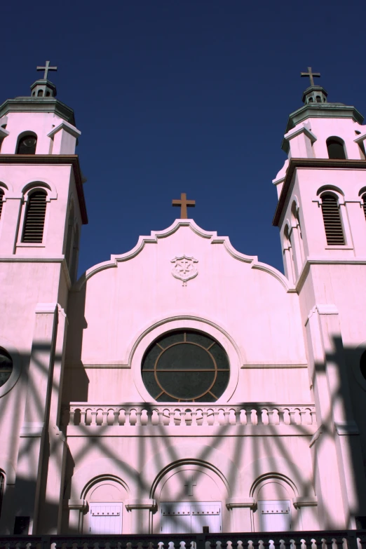 the front of a church has two large towers