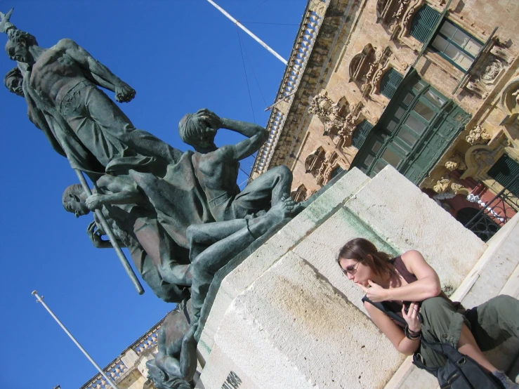 woman taking a picture in front of a statue