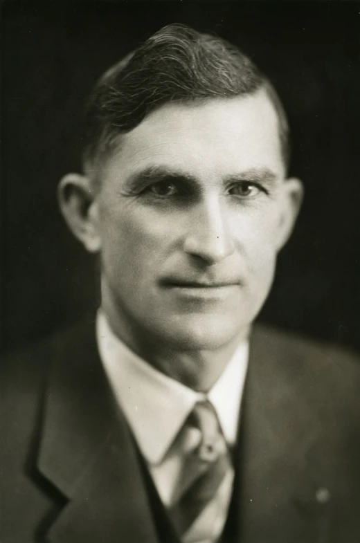 a man in a suit and tie poses for a picture