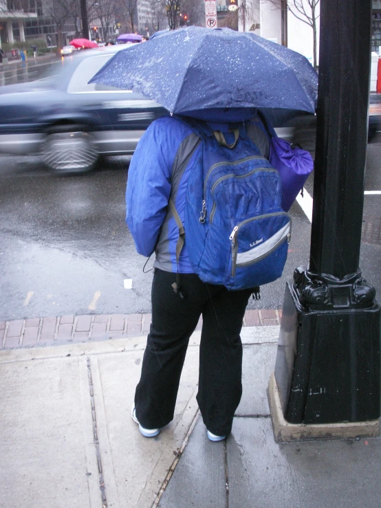 a person that is walking under an umbrella