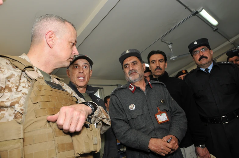 a man in uniform standing next to a group of people