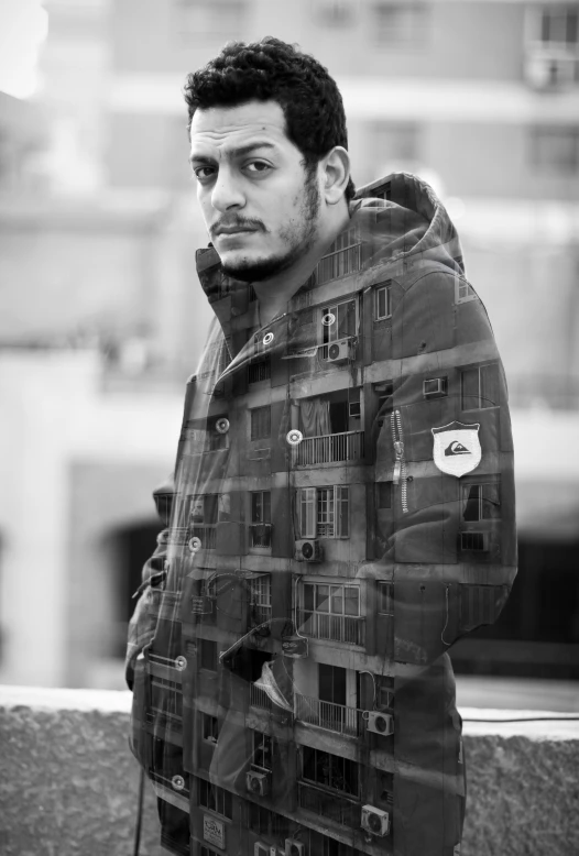 man standing in front of a large building looking at the camera