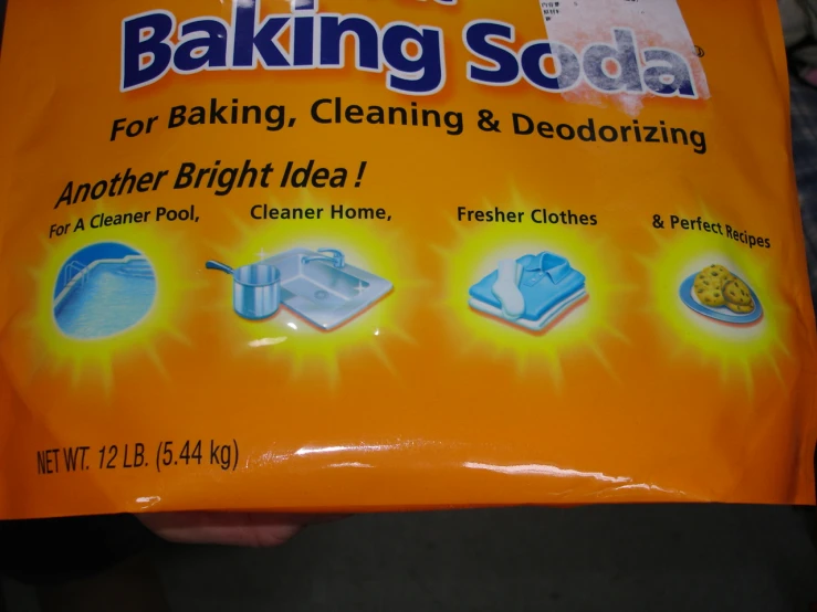 a close up of a person holding a bag of baking soda